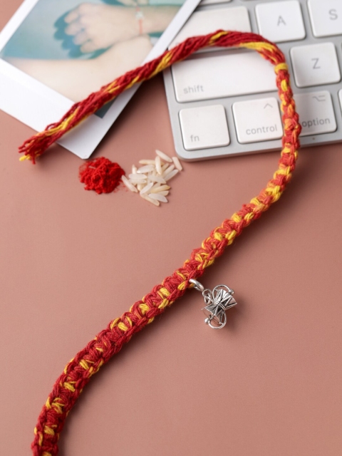 

ADORN by Nikita Ladiwala Rakhi with Sterling Silver Damru pendent, Red