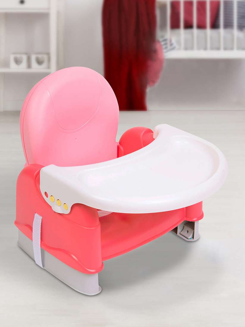 Pink booster seat for table clearance
