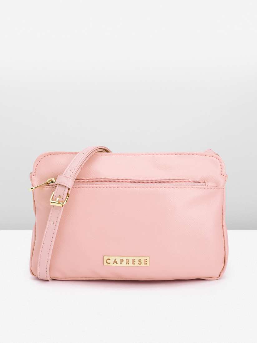 Caprese pink solid sling bag sale